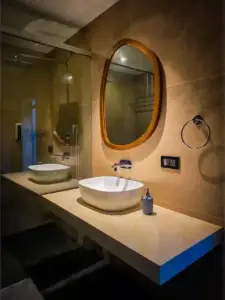 A sleek, modern bathroom featuring organic shapes at this premium villa Kerala riverside.